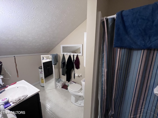 bathroom with vanity, toilet, vaulted ceiling, and a textured ceiling