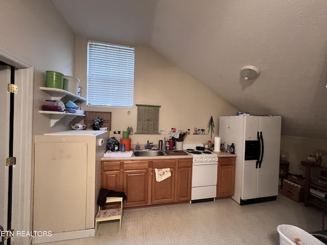 kitchen with vaulted ceiling, sink, and white appliances