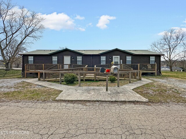view of front of home featuring a deck and metal roof