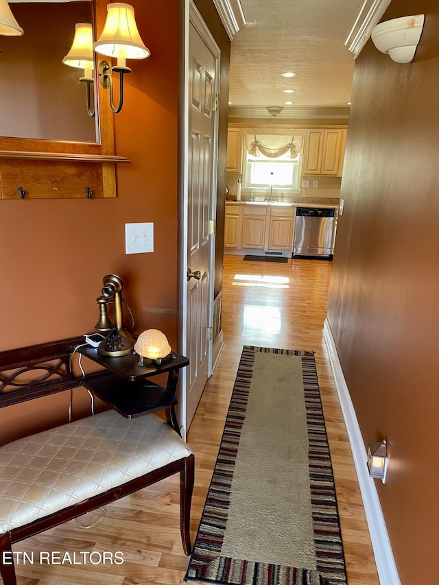 hall with sink and light wood-type flooring