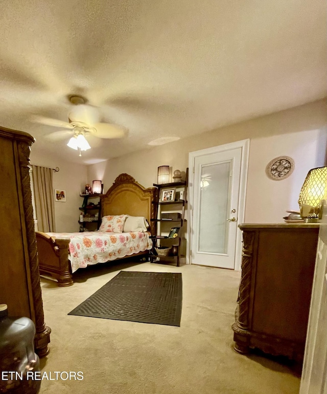 bedroom featuring ceiling fan, light carpet, and a textured ceiling