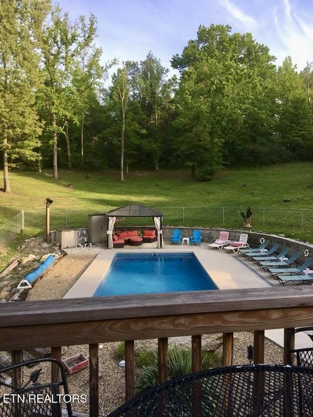 view of pool with a gazebo and a lawn