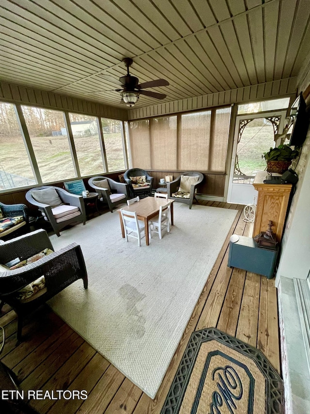 sunroom / solarium with wood ceiling and ceiling fan