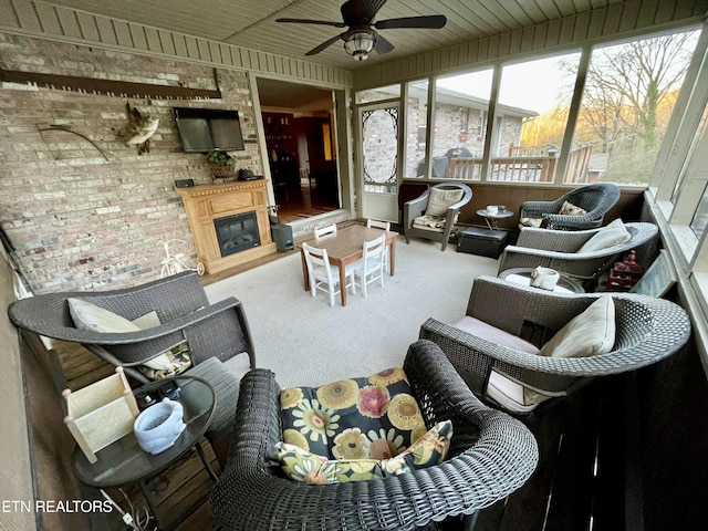 sunroom with wooden ceiling and ceiling fan