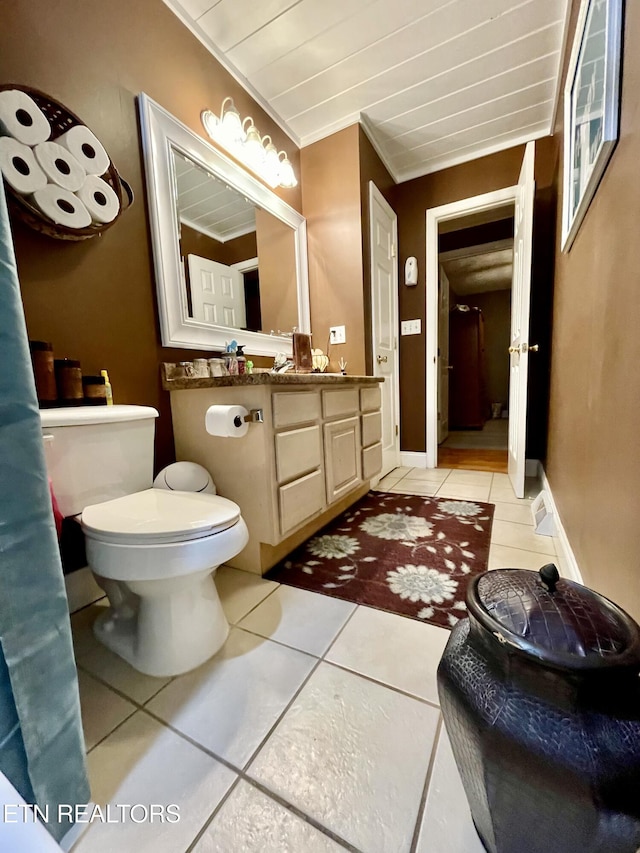 bathroom with crown molding, vanity, toilet, and tile patterned flooring