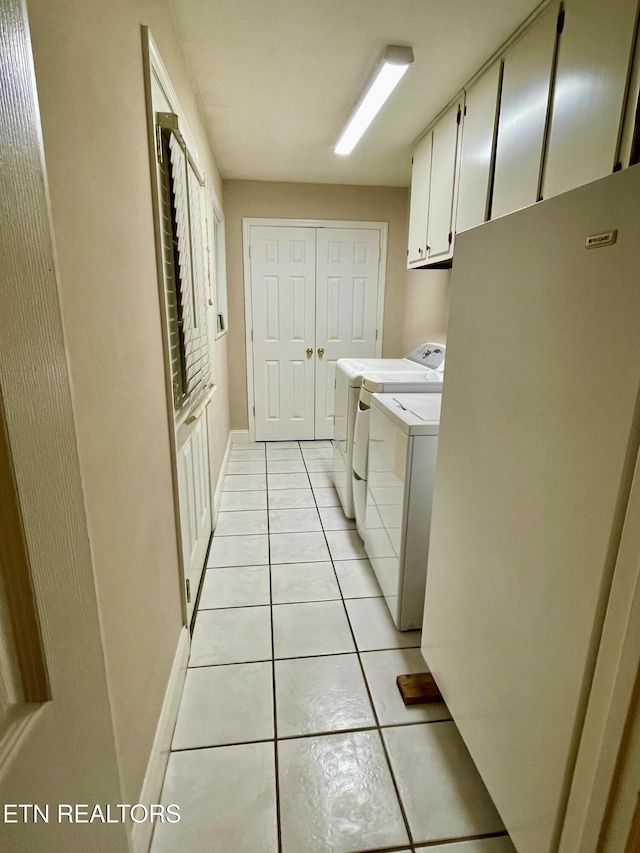 washroom with light tile patterned flooring, cabinets, and separate washer and dryer