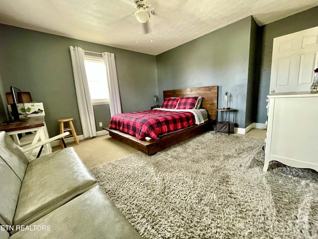 bedroom featuring a textured ceiling, ceiling fan, and carpet flooring