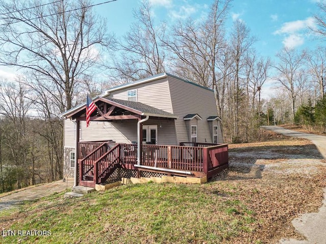 back of house featuring a wooden deck, a yard, and french doors