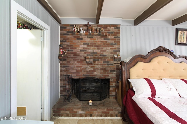 bedroom with beam ceiling and a fireplace