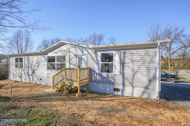 rear view of property with crawl space