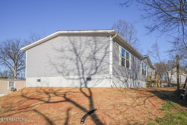 view of side of home featuring crawl space