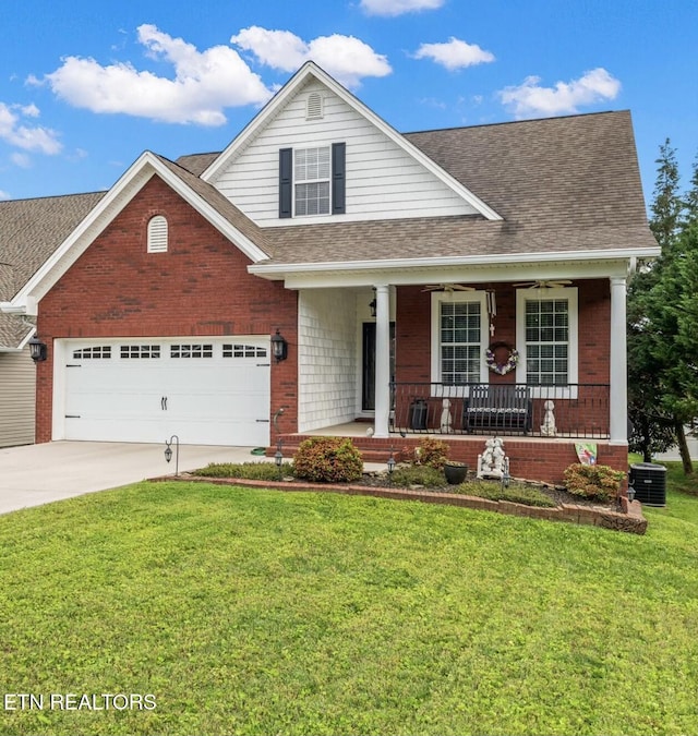 view of front of house featuring central AC, a porch, a garage, and a front yard