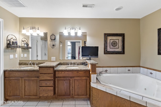 full bathroom featuring tile patterned flooring, visible vents, a sink, and a whirlpool tub