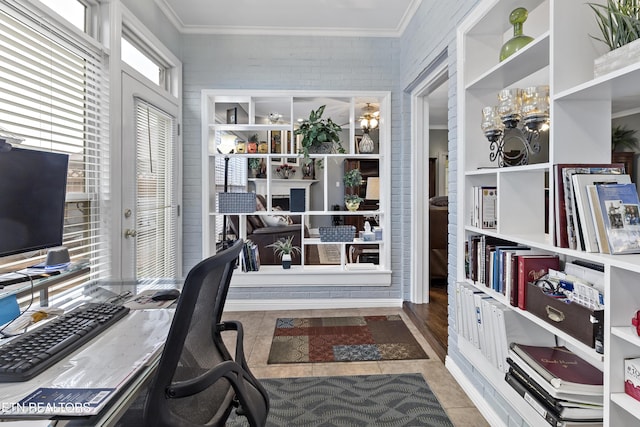 tiled home office with ornamental molding, french doors, and brick wall