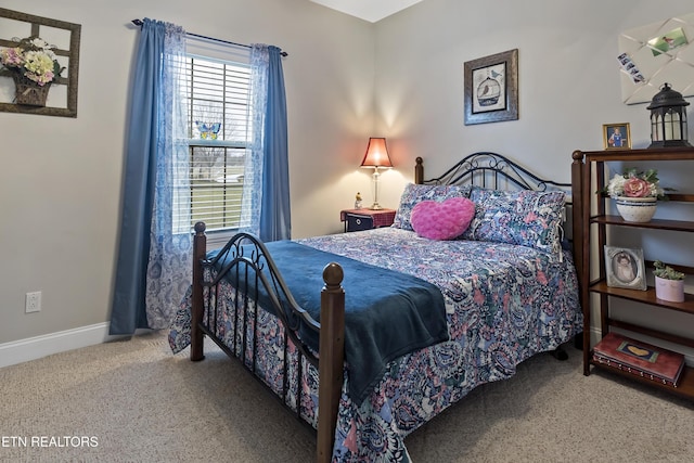 carpeted bedroom featuring baseboards