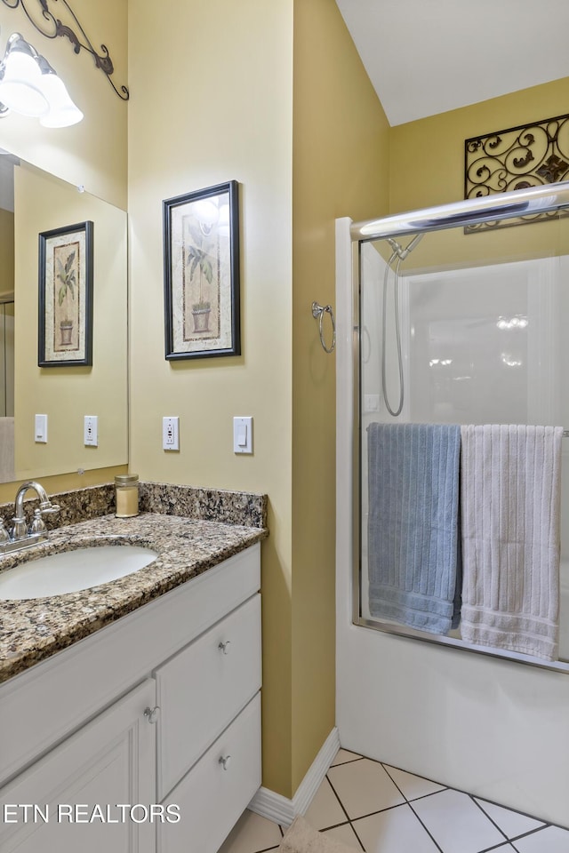 full bath featuring vanity, baseboards, combined bath / shower with glass door, and tile patterned floors