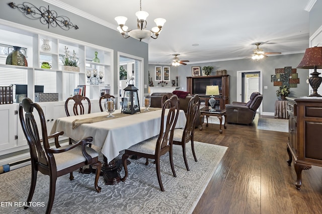 dining room featuring dark wood-style floors, ornamental molding, ceiling fan with notable chandelier, and baseboards