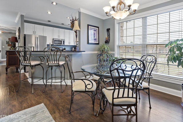 dining area with ornamental molding, recessed lighting, an inviting chandelier, and dark wood-style floors