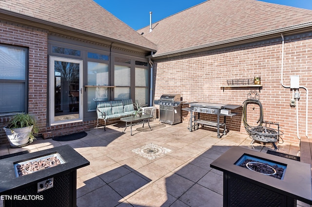 view of patio / terrace featuring an outdoor living space with a fire pit and area for grilling