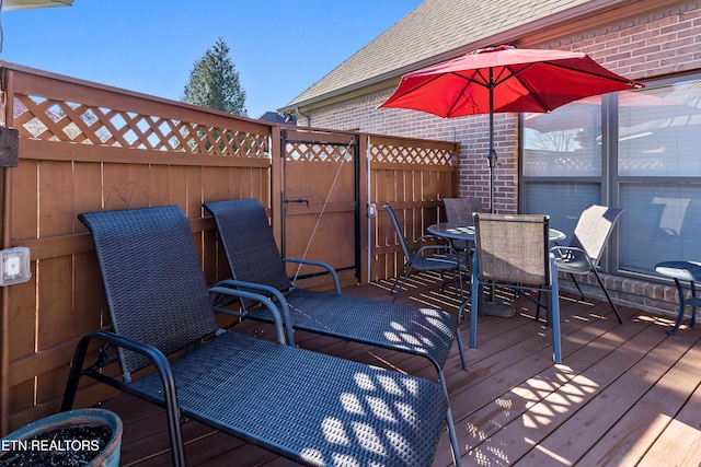 deck featuring fence and outdoor dining area