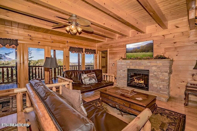 living room featuring beamed ceiling, hardwood / wood-style floors, wooden ceiling, and wooden walls