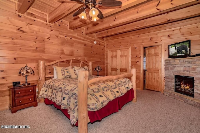 bedroom featuring a stone fireplace, wooden walls, light colored carpet, wood ceiling, and beam ceiling