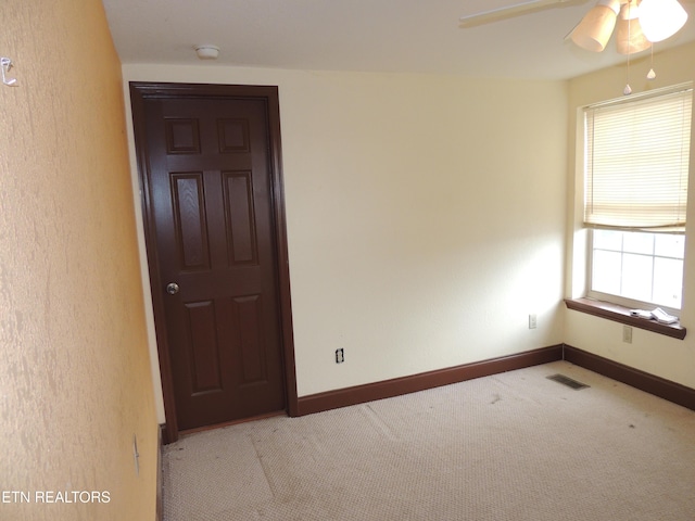 carpeted empty room with ceiling fan