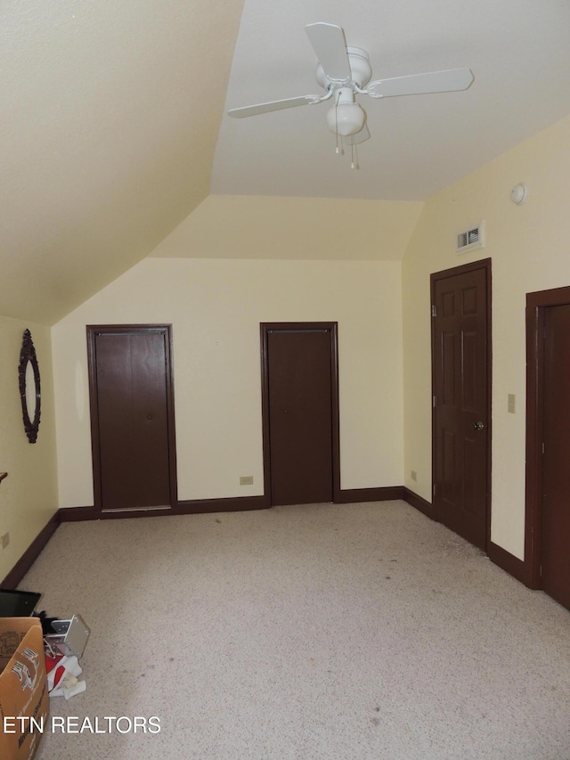 additional living space featuring lofted ceiling, light carpet, and ceiling fan