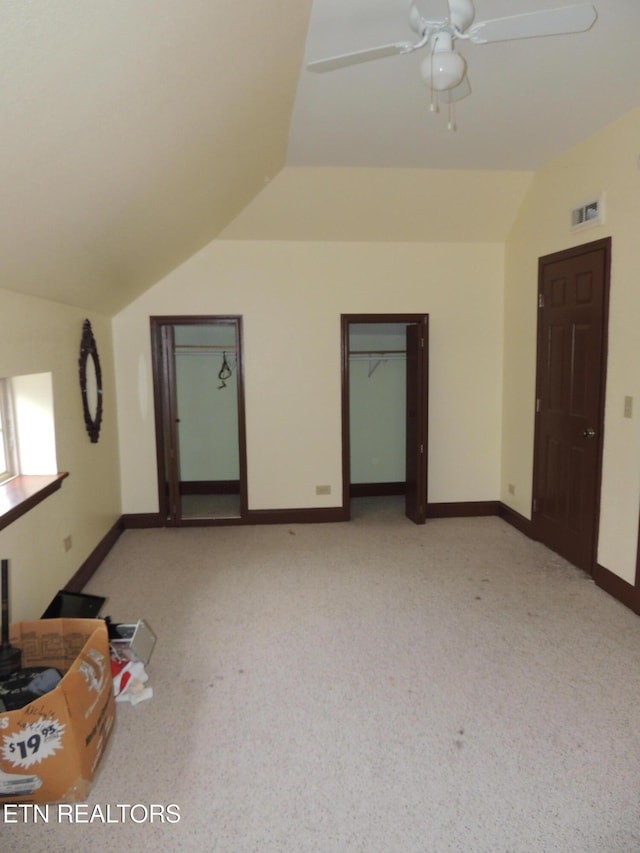 bonus room with vaulted ceiling, light colored carpet, and ceiling fan