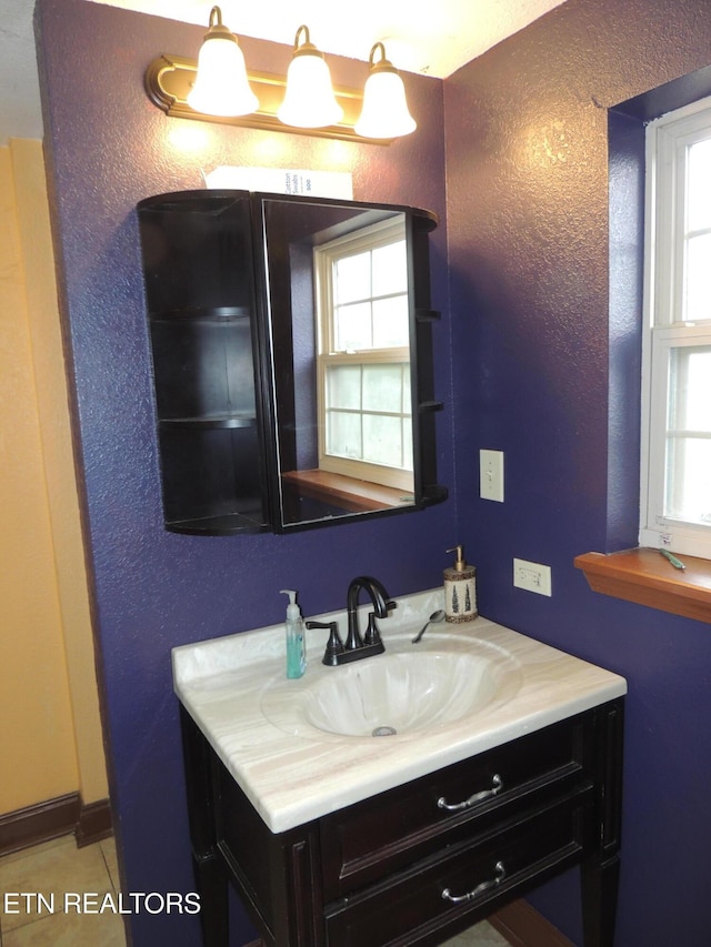 bathroom with tile patterned floors and vanity