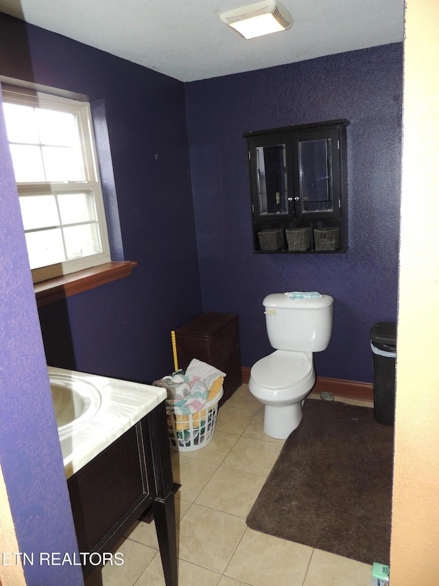 bathroom featuring tile patterned flooring, vanity, and toilet