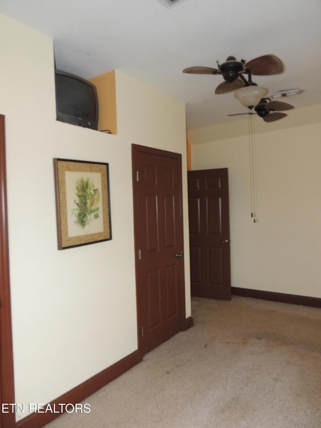 carpeted empty room with ceiling fan