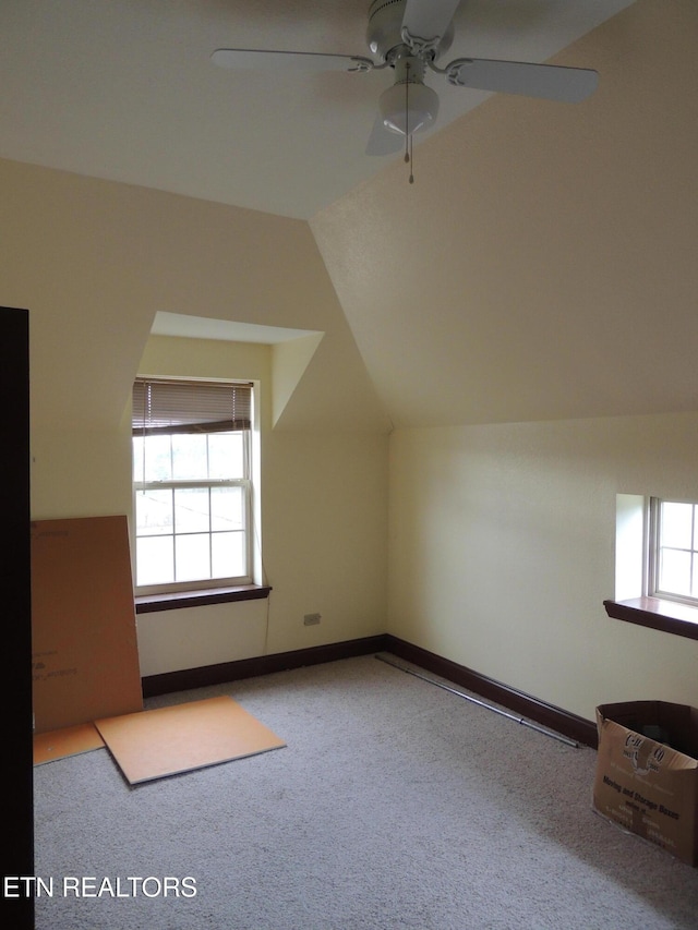 bonus room with ceiling fan, a healthy amount of sunlight, and vaulted ceiling