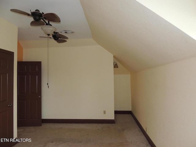 bonus room featuring vaulted ceiling, light colored carpet, and ceiling fan