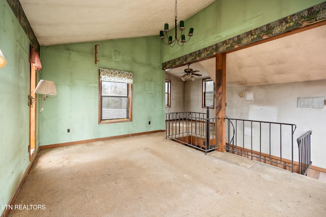 empty room with a healthy amount of sunlight, baseboards, lofted ceiling, and carpet floors