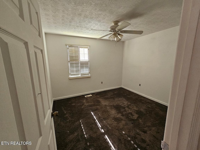 spare room featuring ceiling fan and a textured ceiling