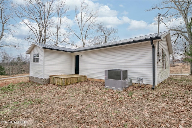 back of house featuring central air condition unit