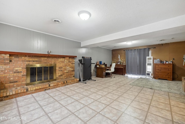 unfurnished living room featuring a fireplace and a textured ceiling