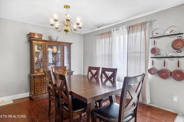 dining room featuring dark hardwood / wood-style floors and a notable chandelier