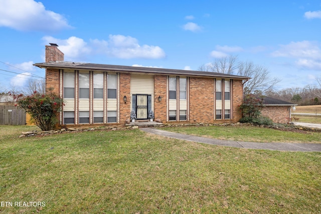 raised ranch featuring a front lawn