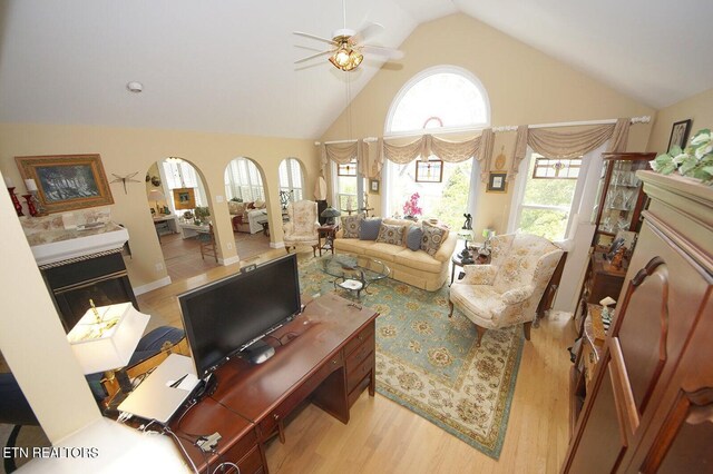 3413 Commodore Pt, Knoxville, TN 37922 - living area featuring a glass covered fireplace, ceiling fan, wood finished floors, and high vaulted ceiling