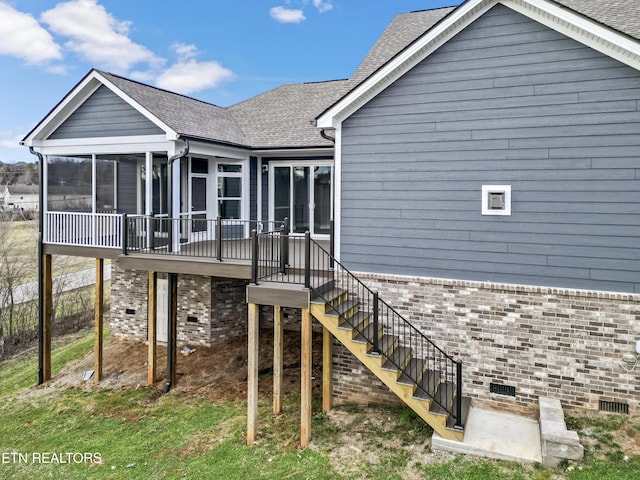 rear view of property featuring a sunroom