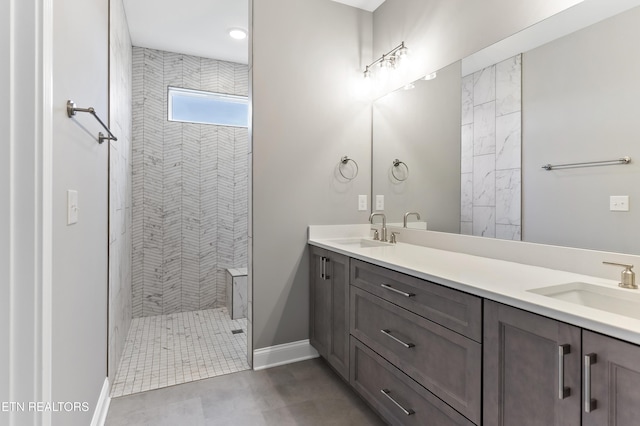 bathroom with vanity and tiled shower