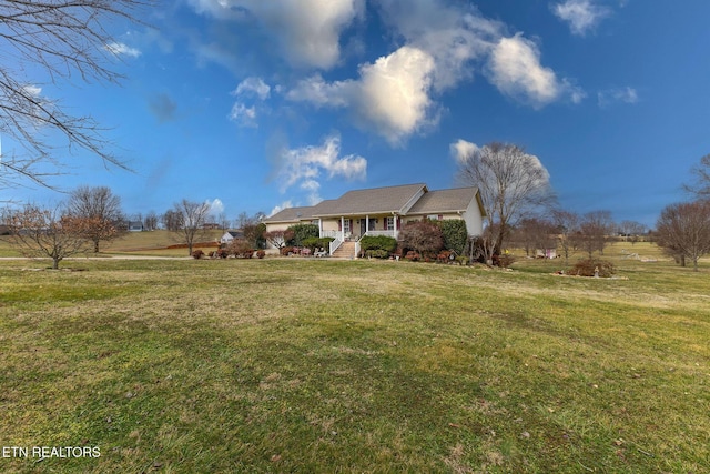 ranch-style house featuring covered porch and a front lawn