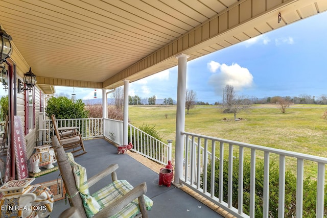 view of patio featuring a rural view and a porch