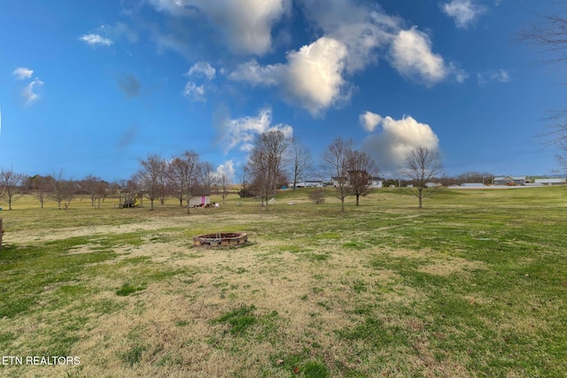 view of yard with a fire pit and a rural view