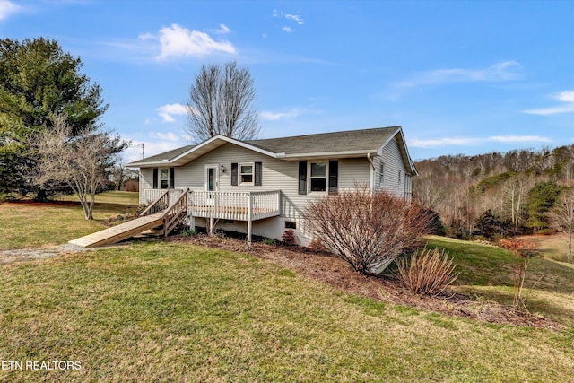 view of front of house with a deck, a front yard, and stairs