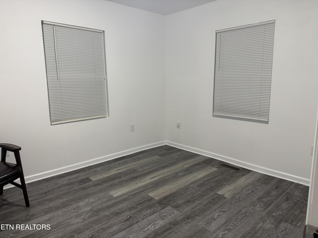 spare room featuring dark hardwood / wood-style flooring