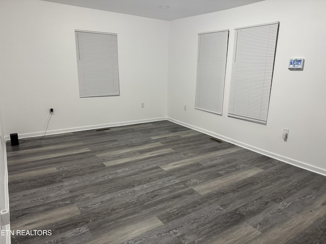 empty room featuring dark wood-type flooring