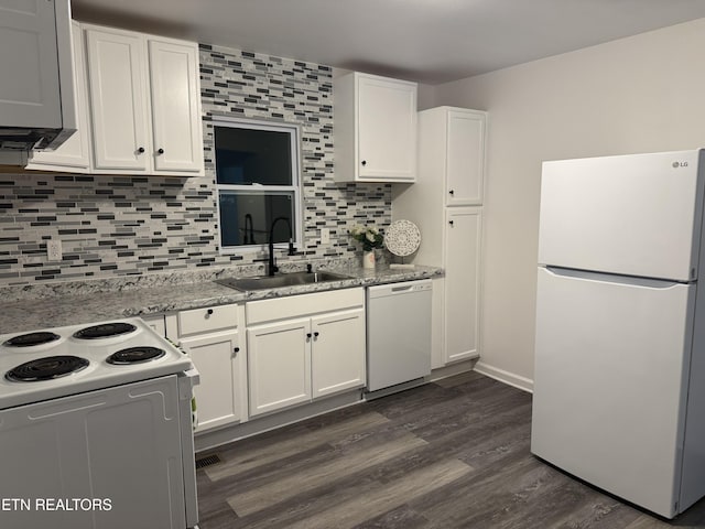 kitchen with white cabinetry, sink, dark hardwood / wood-style flooring, light stone counters, and white appliances